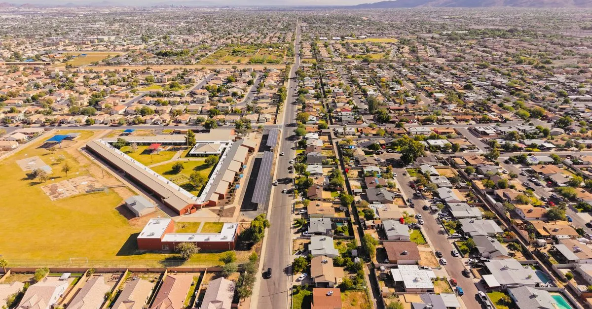 Aerial view of a sprawling residential area in Arizona under a bright day sky.